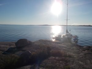 Shows the boat moored up at a rocky island in Sweden